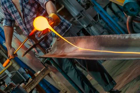 Close up of molten glass being processed Stock Photos