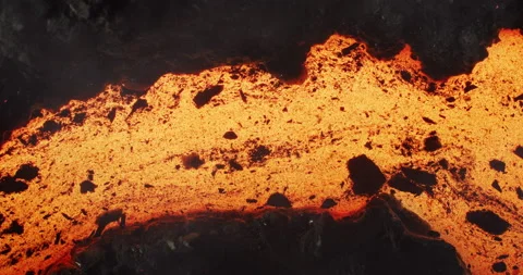 Close up of molten lava stream on a dark stone background in slow motion. Stock Footage 143708277