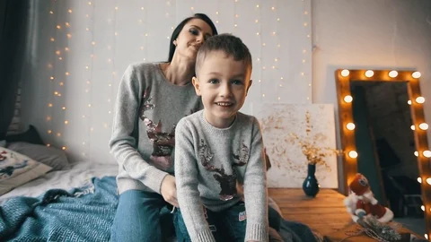 Close up mom and son playing on a bed Stock Footage 121972485