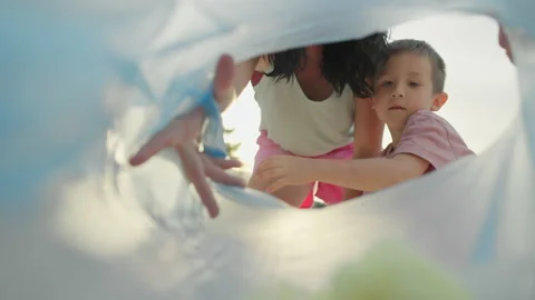 Close-up of mom with baby throwing garbage in garbage bag. Stock Footage 196967200