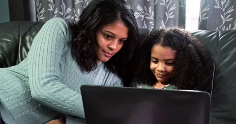 Close up, Mom, daughter using laptop for internet or education. Stock Footage 319066310