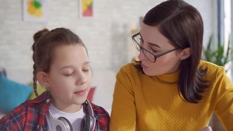 Close up mom helping daughter do homework Stock Footage 105683155