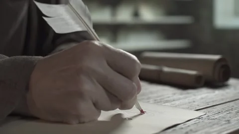 Close up of monk hand illuminating an initial letter with a feather pen Stock Footage 338992090