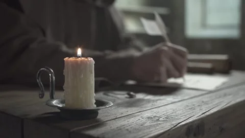 Close up of monk hands extinguishing a candle with a snuffer, dark scriptorium 스톡 동영상 339231900