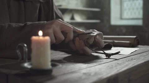 Close up of monk hands sharpening a penknife blade on a wet whetstone surface Video stock 340079617