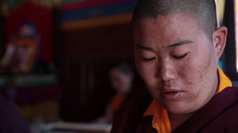 Close up of a monk (nun) reading the ancient buddhist script during a ritual. Stock Footage 31842512