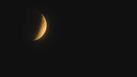 A close-up of the Moons partial eclipse to a crescent moon Stock Footage 317969852