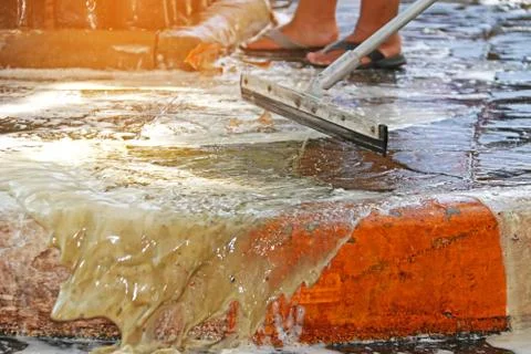 Close up mop worker cleaning dirty footpath Stock Photos