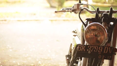 Close up of moped as bikes pass on the road behind Stock-Footage 72713501