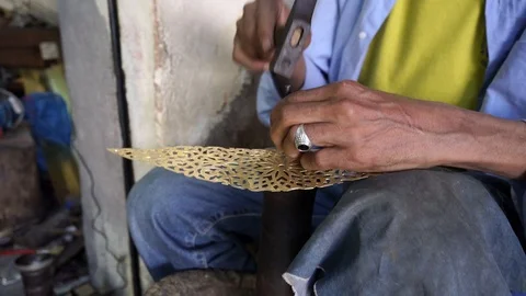 Close up of Moroccan artisan's hands working on metal Stock Footage 110851187