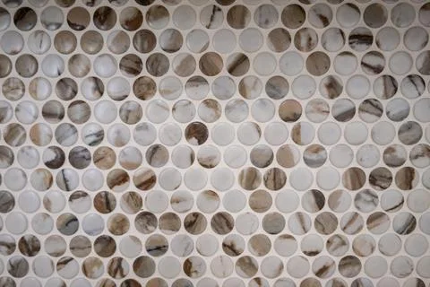 Close-up of a mosaic tile pattern in neutral tones.  Rounded tiles create a.. Stock Photos