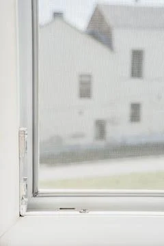 Close up on mosquito wire screen installation on window to protect 写真素材