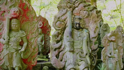Close up of mossy Jizo statue holding Khakkhara staff in sacred forest Stock Footage 339041553