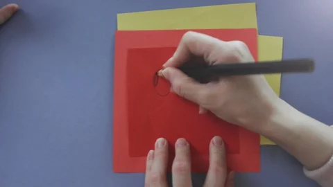 Close up mother and daughter's hands holding pencil drawing an amazed face on Stock Footage 104167082