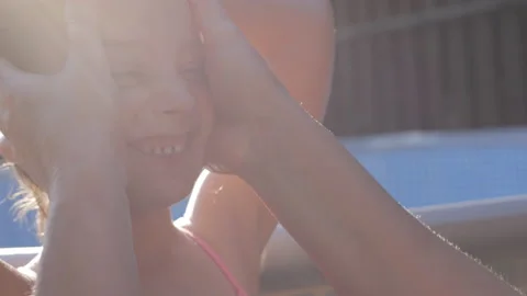 Close up of mother applying protective sunscreen or sunblock lotion on her Stock Footage 201340209