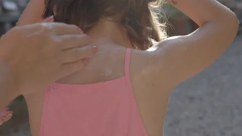 Close up of mother applying protective sunscreen or sunblock lotion on her Stock Footage 201356838