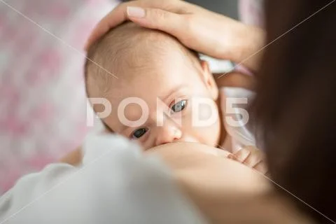 Close up of mother breastfeeding newborn baby Stock Photos