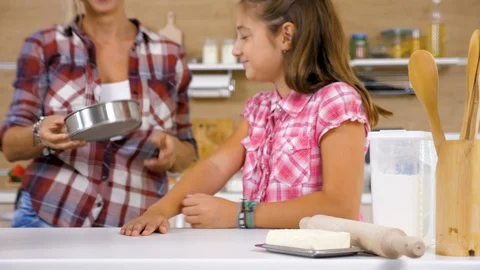 Close up of Mother bringing from the back of the kitchen a sieve Stock Footage 96506640