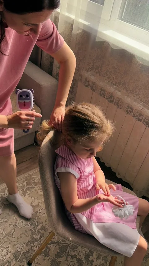 Close-up of mother hands weaving a delicate braid in her daughter's fine hair Stock Footage 311041380