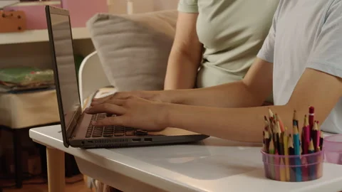 Close-up of mother helping son with computer homework at home Stock Footage 317411530
