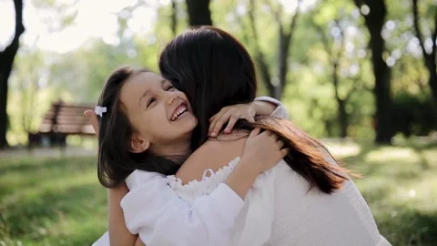 Close up of a mother lovingly embracing her daughter Stock Footage 263307525