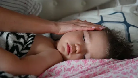 Close up of mother stroking head of sleeping baby son. Caring for child concept. Stock Footage 152507733