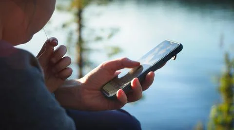 Close up. Mother using her mobile phone apps browsing chatting playing web Stock Photos