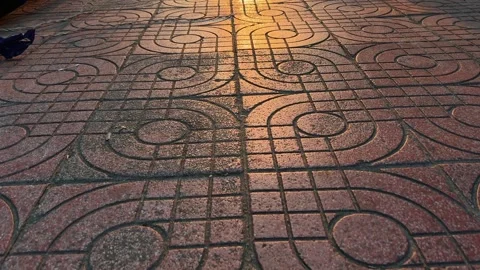 Close Up motion above Ornate Decorative Stone Pavement Pattern illuminated by Stock Footage 342369841