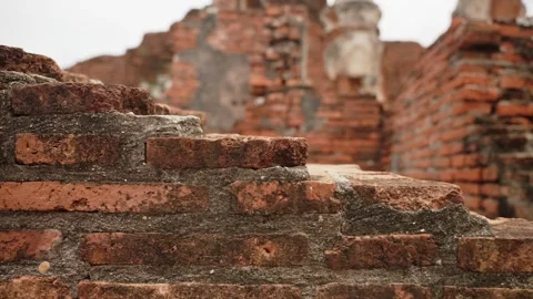 Close-up motion along of ancient red brick wall at temple ruins in Ayutthaya Stock-Footage 312661911