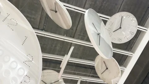 Close up motion between Many Large Round White Wall Clocks Hanging Display Stock Footage 342890548