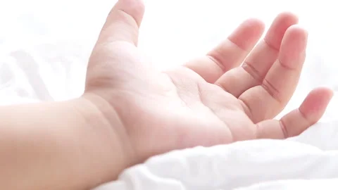 Close up motion of child hand on white fabric background. Stock Footage 136494593