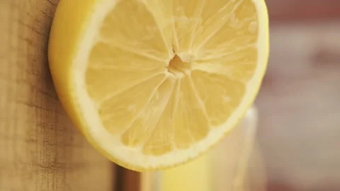 Close up motion of fresh lemon slice juicy refreshing citrus fruit on woode.. Stock Footage 332909075