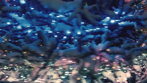 Close-up in motion of glowing Christmas tree, covered with lot of snow. 스톡 동영상 81744815
