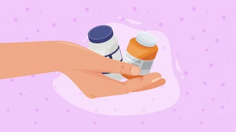 Close up motion graphic video of a hand catching and holding two medicine b.. Stock Footage 339062686
