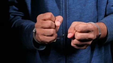 Close up motion of hands being cuffed by police arrest with handcuffs. Stock Footage 332623412