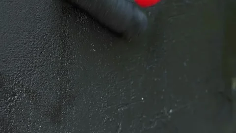 Close-up motion of paint roller applying black waterproofing liquid on conc.. Stock Footage 339213630