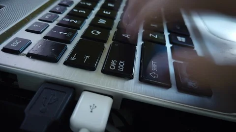 Close-up motion panning time lapse of hand typing on a keyboard of lap top. High Video stock 119540739