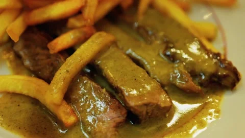 Close up motion shot of steak frites, a classic dish featuring sliced steak.. Stock Footage 339753264