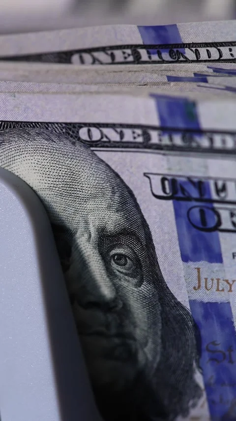 Close-up motion view of 100 dollar bills being counted by cash counting mac.. Stock Footage 337633796