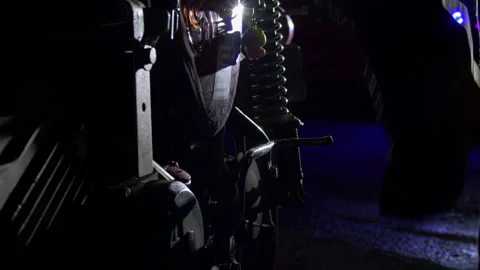 Close-up of a motorcycle being handled at night, with suspension, wheel and Vidéo 344059115