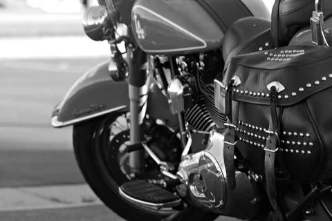 Close-up of motorcycle controls and windshield with marina masts in the Stock Photos