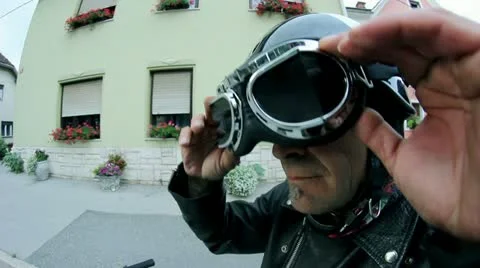 Close up on motorcycle driver putting on protection glasses Stock Footage 28983079