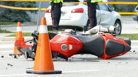 Close up of motorcycle on the ground after accident with debris Stock Footage 99011998