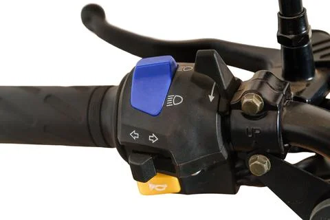 Close up of motorcycle handlebar controls with blue light switch and yellow.. Stock Photos
