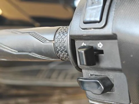 Close-up of motorcycle handlebar switch and turn signal control button Stock Photos