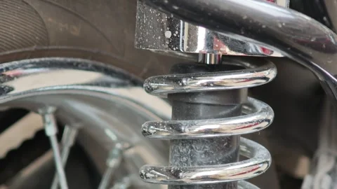 Close up on motorcycle shock absorber, examining functionality and design Vidéo 310409085