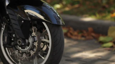 Close up of motorcycle wheel stops Stock Footage 48568061