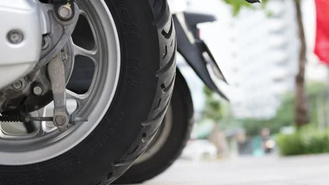 Close up of motorcycle wheels in city. Video stock 303368770