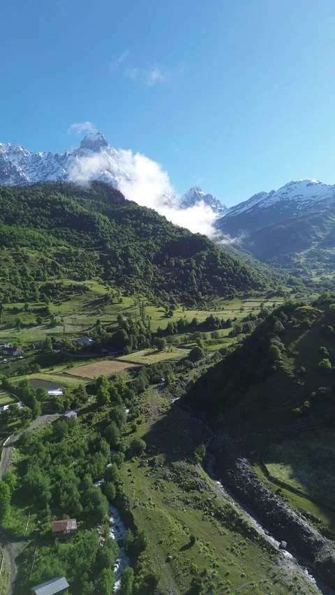 Close Up Mountain Slope Approach With Low Cloud Vertical Drone 4K RAW Stock Footage 339734393