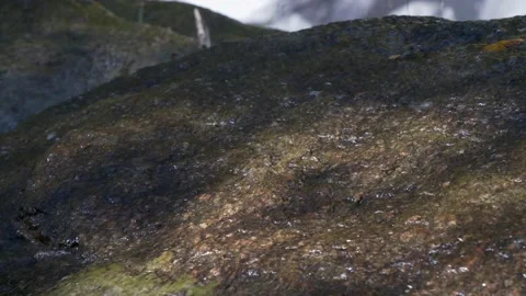 Close-up mountain water flows over rocky surface. Slow motion 4K 库存影片 238611919